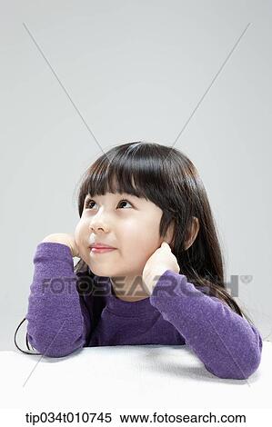 Stock Photography - a girl leaning on a chair. Fotosearch