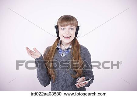 a girl listening to music with headphone View Large Photo Image Stock Image - a girl listening to music with headphone. Fotosearch