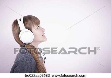 a girl listening to music with headphone View Large Photo Image Stock Image - a girl listening to music with headphone. Fotosearch