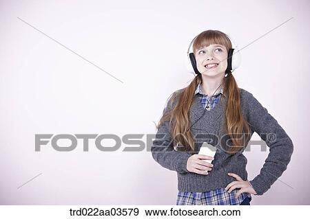 a girl listening to music with headphone View Large Photo Image Stock Photo - a girl listening to music with headphone. Fotosearch