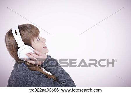 a girl listening to music with headphone View Large Photo Image Stock Photograph - a girl listening to music with headphone. Fotosearch