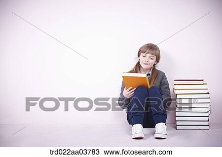 a girl next to several books View Large Photo Image Stock Image - a girl next to several books. Fotosearch