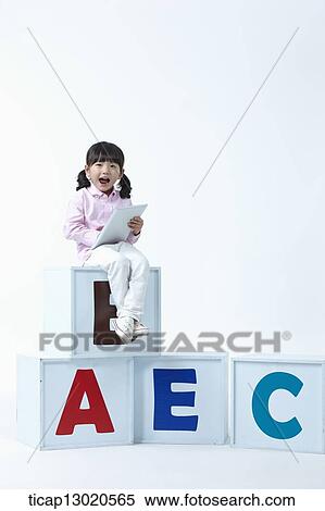 a girl sitting on boxes with alphabets View Large Photo Image Stock Photography - a girl sitting on boxes with alphabets. Fotosearch