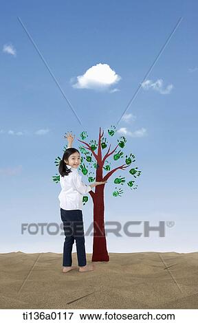 a girl standing in front of a tree View Large Photo Image Stock Photo - a girl standing in front of a tree . Fotosearch
