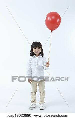 Stock Image - a girl with a balloon. Fotosearch