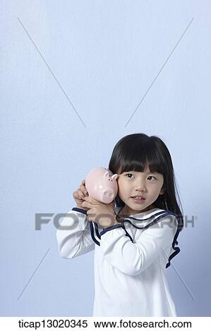 a girl with a piggy bank View Large Photo Image Stock Photography - a girl with a piggy bank. Fotosearch