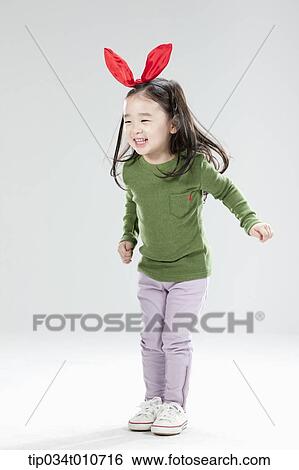 a girl with bunny hair band posing View Large Photo Image Stock Photograph - a girl with bunny hair band posing. Fotosearch