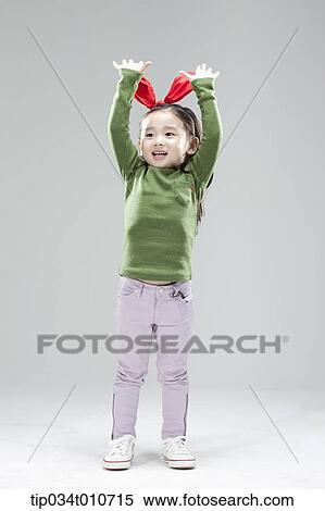 Stock Photography - a girl with bunny hair band posing. Fotosearch