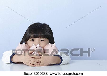 Stock Photo - a girl with piggy banks. Fotosearch