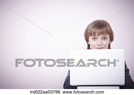 a girl with several books and a laptop View Large Photo Image Stock Photo - a girl with several books and a laptop. Fotosearch
