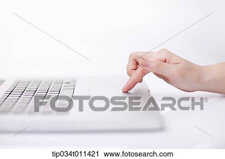 Stock Image - a hand using a laptop. Fotosearch