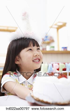 a kid giving someone a birthday cake View Large Photo Image Stock Photo - a kid giving someone a birthday cake. Fotosearch