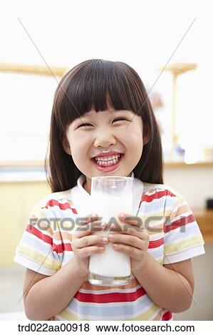 a kid holding a glass of milk View Large Photo Image Stock Photo - a kid holding a glass of milk. Fotosearch