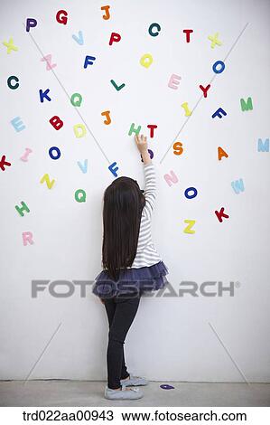 a kid playing with alphabet blocks on the wall View Large Photo Image Stock Image - a kid playing with alphabet blocks on the wall. Fotosearch