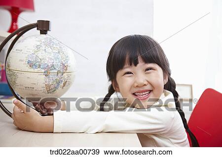 a kid studying with globe at table View Large Photo Image Stock Photo - a kid studying with globe at table. Fotosearch