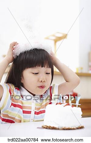 a kid with a birthday cake in front View Large Photo Image Picture - a kid with a birthday cake in front. Fotosearch