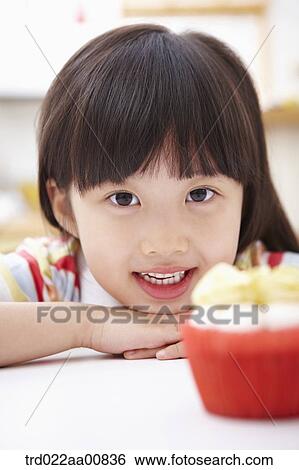 a kid with a paper cup of cookies View Large Photo Image Stock Photograph - a kid with a paper cup of cookies. Fotosearch