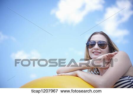 Stock Photo - a lady in bikini and beach tube posing. Fotosearch