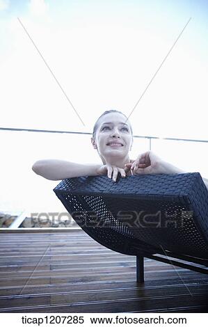a lady in bikini lying on a beach bed View Large Photo Image Stock Photography - a lady in bikini lying on a beach bed. Fotosearch