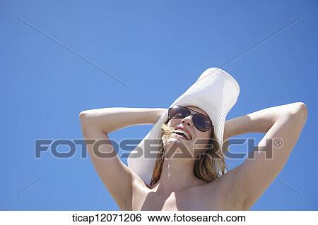 a lady in bikini with a beach hat View Large Photo Image Stock Photograph - a lady in bikini with a beach hat. Fotosearch
