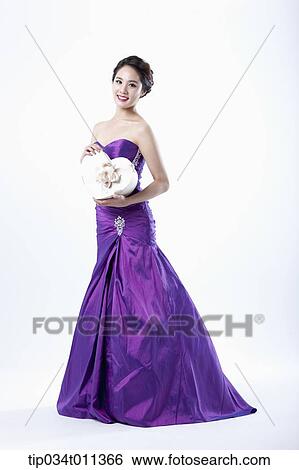 a lady in fancy purple dress holding a heart shaped box View Large Photo Image Stock Photograph - a lady in fancy purple dress holding a heart shaped box. Fotosearch