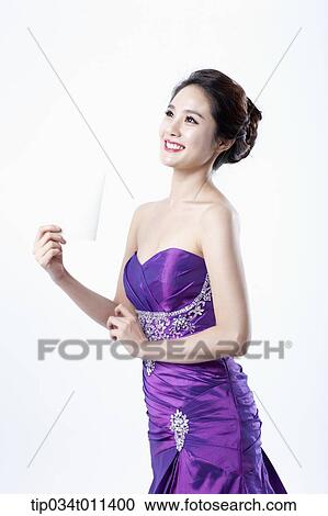 Stock Image - a lady in fancy purple dress holding an envelope. Fotosearch