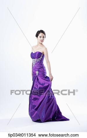 Picture - a lady in fancy purple dress posing gracefully. Fotosearch