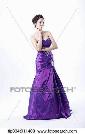 Stock Photo - a lady in fancy purple dress posing . Fotosearch