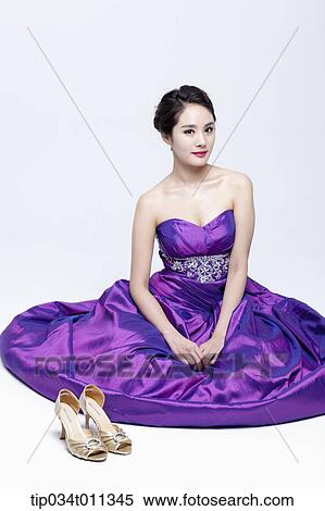 Stock Photography - a lady in fancy purple dress sitting on the floor gracefully. Fotosearch