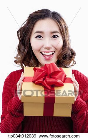 a lady in red sweater holding a gift box View Large Photo Image Stock Photo - a lady in red sweater holding a gift box. Fotosearch
