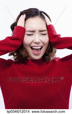 Picture - a lady in red sweater looking stressed. Fotosearch