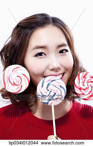 a lady in red sweater posing with lollipops View Large Photo Image Picture - a lady in red sweater posing with lollipops. Fotosearch