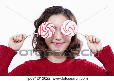 Stock Image - a lady in red sweater posing with lollipops. Fotosearch