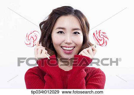 Stock Photo - a lady in red sweater posing with lollipops. Fotosearch