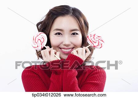 Stock Photograph - a lady in red sweater posing with lollipops. Fotosearch