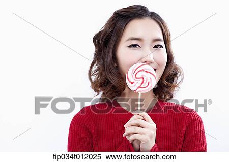 a lady in red sweater posing with lollipop View Large Photo Image Stock Photography - a lady in red sweater posing with lollipop. Fotosearch