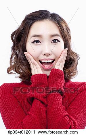 Stock Image - a lady in red sweater smiling . Fotosearch