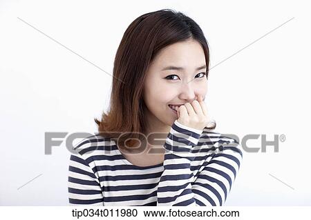 Stock Image - a lady in striped clothes looking happy. Fotosearch