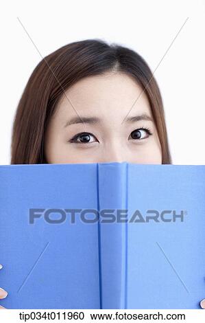 Stock Image - a lady in striped clothes posing with a book. Fotosearch