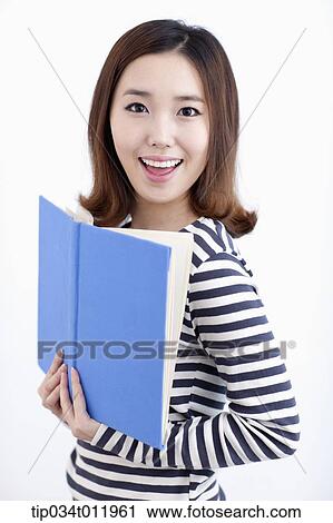 Stock Image - a lady in striped clothes posing with a book. Fotosearch
