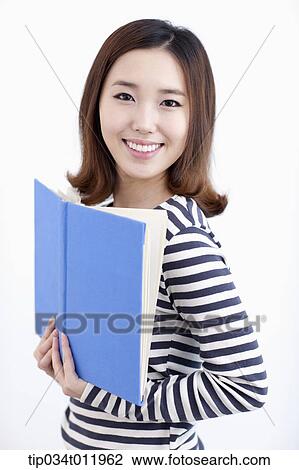 Stock Image - a lady in striped clothes posing with a book. Fotosearch