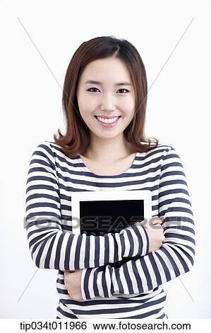 a lady in striped clothes posing with a tablet PC View Large Photo Image Stock Photograph - a lady in striped clothes posing with a tablet PC. Fotosearch