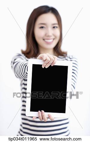 a lady in striped clothes posing with a tablet PC View Large Photo Image Stock Photography - a lady in striped clothes posing with a tablet PC. Fotosearch