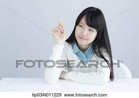 a lady leaning on a desk with a pencil View Large Photo Image Stock Photo - a lady leaning on a desk with a pencil. Fotosearch