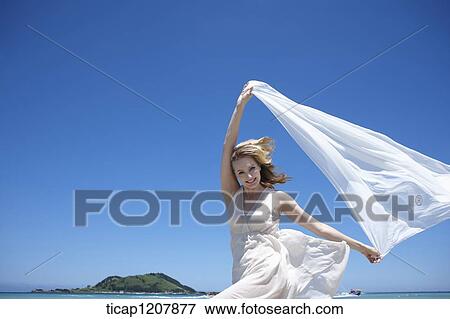 a lady running on the beach with white cloth View Large Photo Image Stock Photo - a lady running on the beach with white cloth. Fotosearch