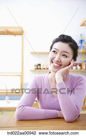 a lady smiling while sitting at table View Large Photo Image Stock Image - a lady smiling while sitting at table. Fotosearch