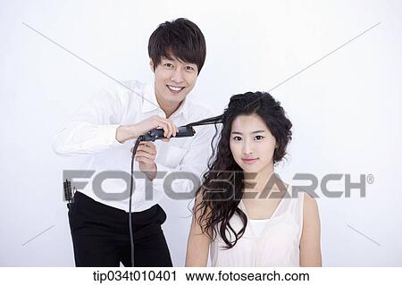 a male hairdresser taking care of woman's hair View Large Photo Image Stock Image - a male hairdresser taking care of woman's hair . Fotosearch