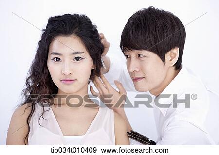 a male hairdresser taking care of woman's hair View Large Photo Image Stock Photo - a male hairdresser taking care of woman's hair . Fotosearch