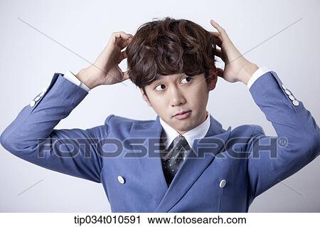 Stock Image - a man looking confused. Fotosearch