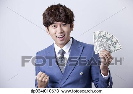 a man looking happy while holding dollars View Large Photo Image Stock Image - a man looking happy while holding dollars . Fotosearch